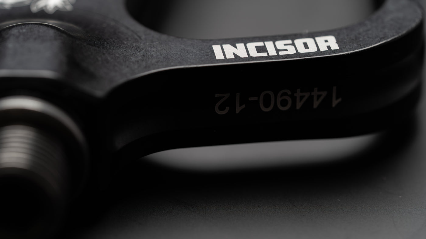Close-up of the Dropbear Incisor pedal body showing the engraved Incisor logo and axle bore