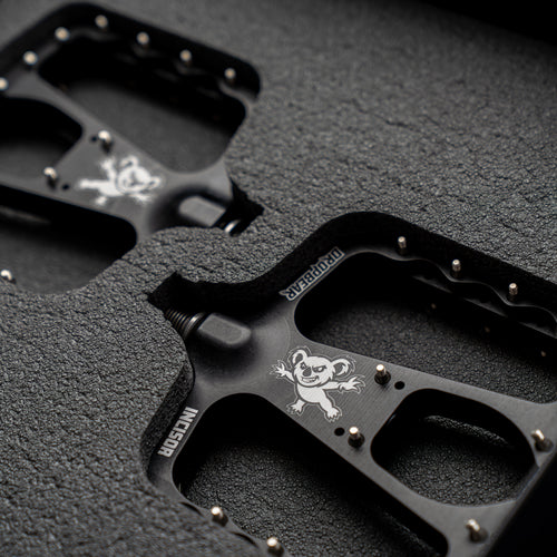 Dropbear pedals with koala logo on the pedal. Surrounded by a foam padding. Dark surrounding