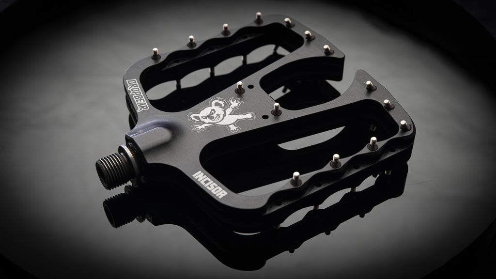 Dropbear Incisor black flat pedal with 30 stainless steel pins and koala logo, product studio shot