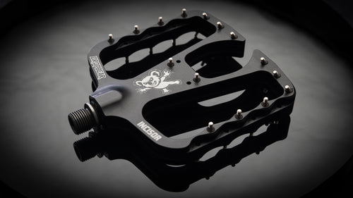 Dropbear Incisor black flat pedal with 30 stainless steel pins and koala logo, product studio shot